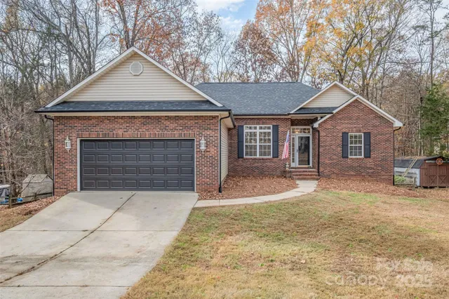a front view of a house with yard and garage