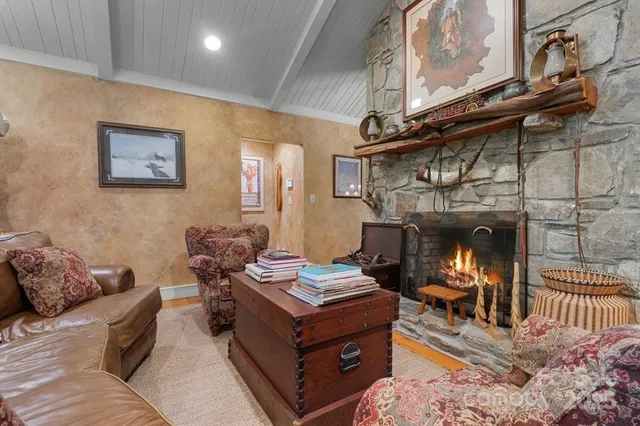 a living room with furniture a flat screen tv and a floor to ceiling window
