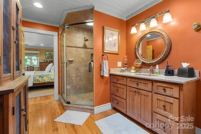 a en suite bathroom with a granite countertop mirror and shower