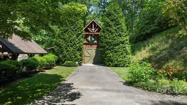 a view of a house with balcony and wooden fence