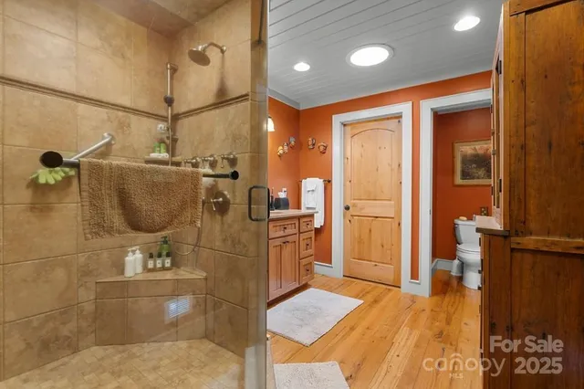a bathroom with a granite countertop sink mirror vanity and toilet