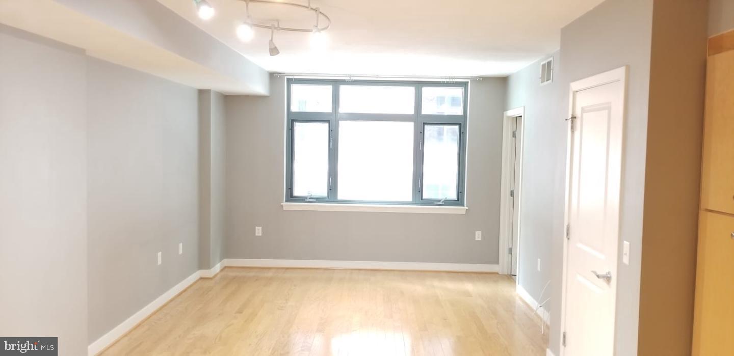 1117 10th Street Northwest, Unit 210 Washington, DC 20001 - Photo 11 of 15 a view of an empty room with a window