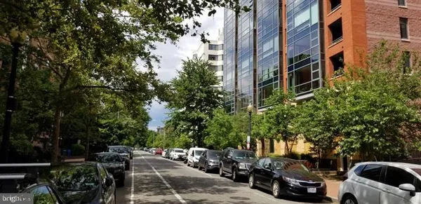 a view of a cars park in front of a building