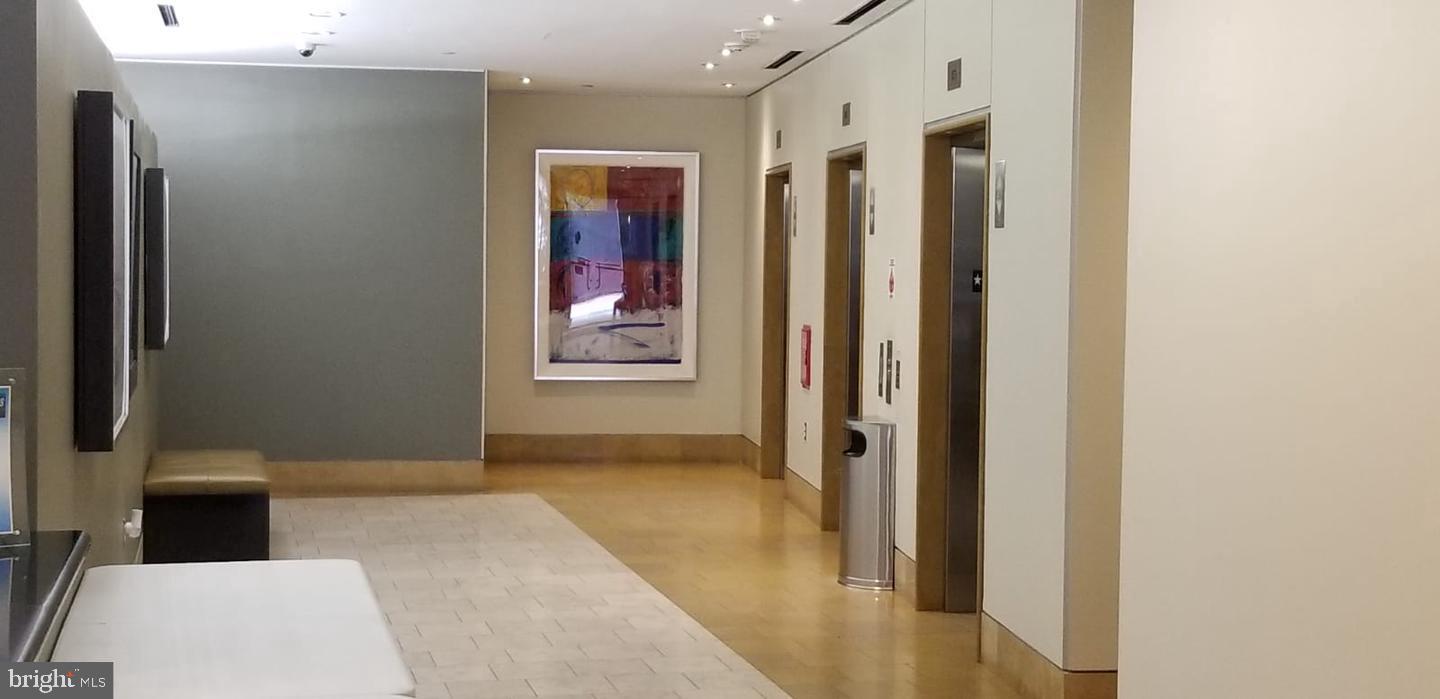 1117 10th Street Northwest, Unit 210 Washington, DC 20001 - Photo 9 of 15 a view of a hallway with wooden floor and a bathroom