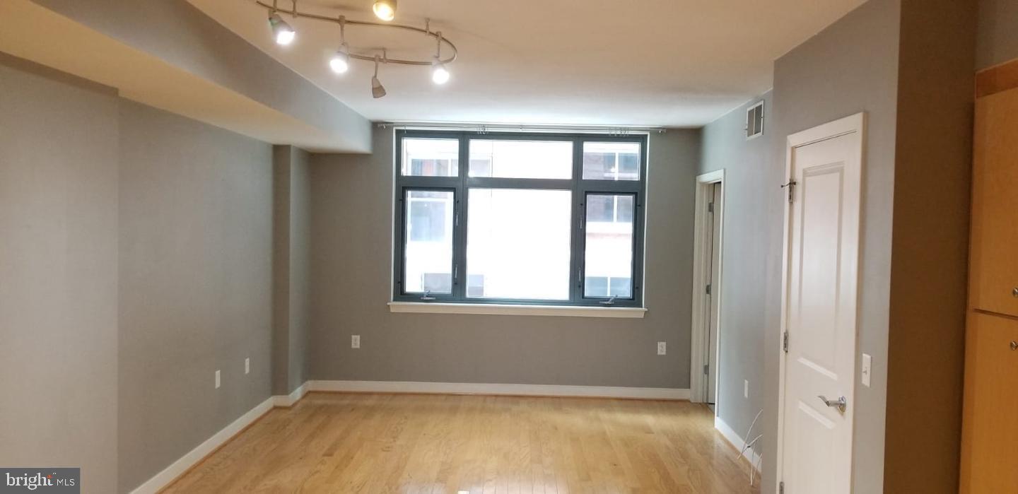 1117 10th Street Northwest, Unit 210 Washington, DC 20001 - Photo 10 of 15 a view of an empty room with a window