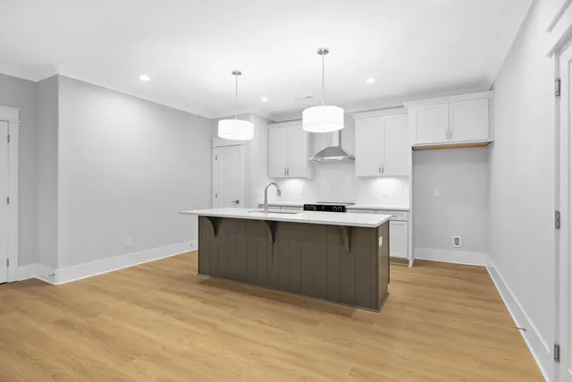 a kitchen with kitchen island a sink stainless steel appliances and cabinets