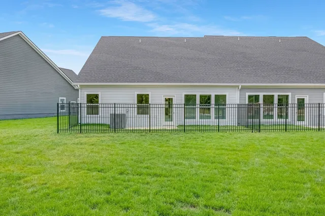 a backyard of a house with table and chairs