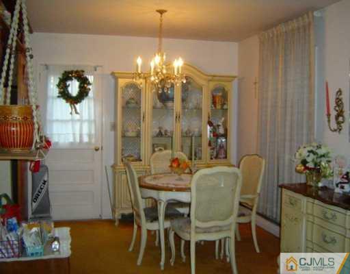 26 Baldwin Road Edison, NJ 08817 - Photo 3 of 8 a view of a dining room with furniture and chandelier