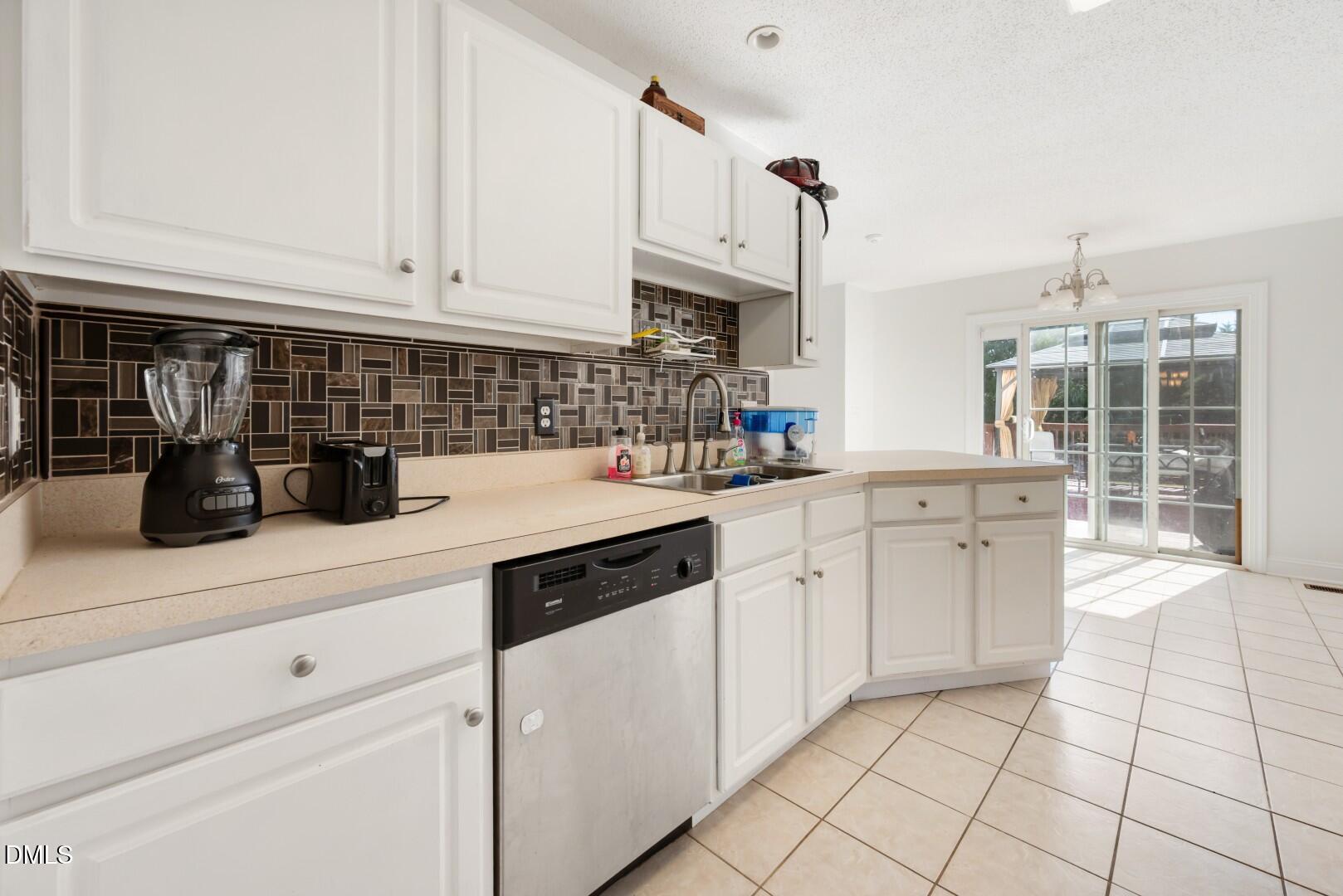 66 Snowden Lane Cameron, NC 28326 - Photo 16 of 55 a kitchen with white cabinets and appliances