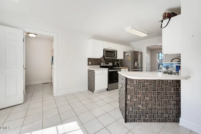 a kitchen with stainless steel appliances a sink stove and cabinets