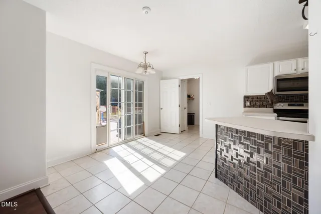 a kitchen with cabinets and window