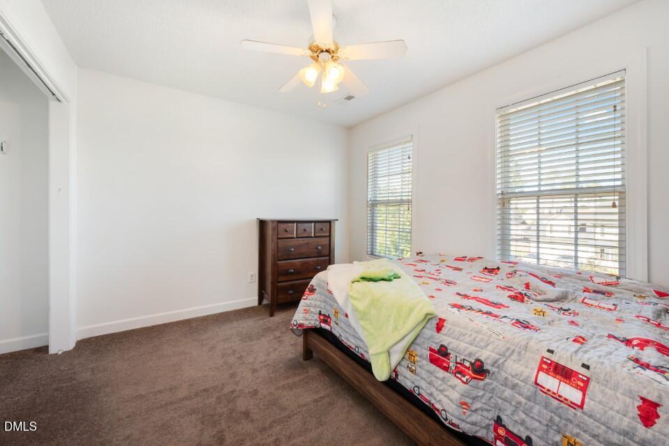 66 Snowden Lane Cameron, NC 28326 - Photo 25 of 55 a bedroom with a bed and a chandelier