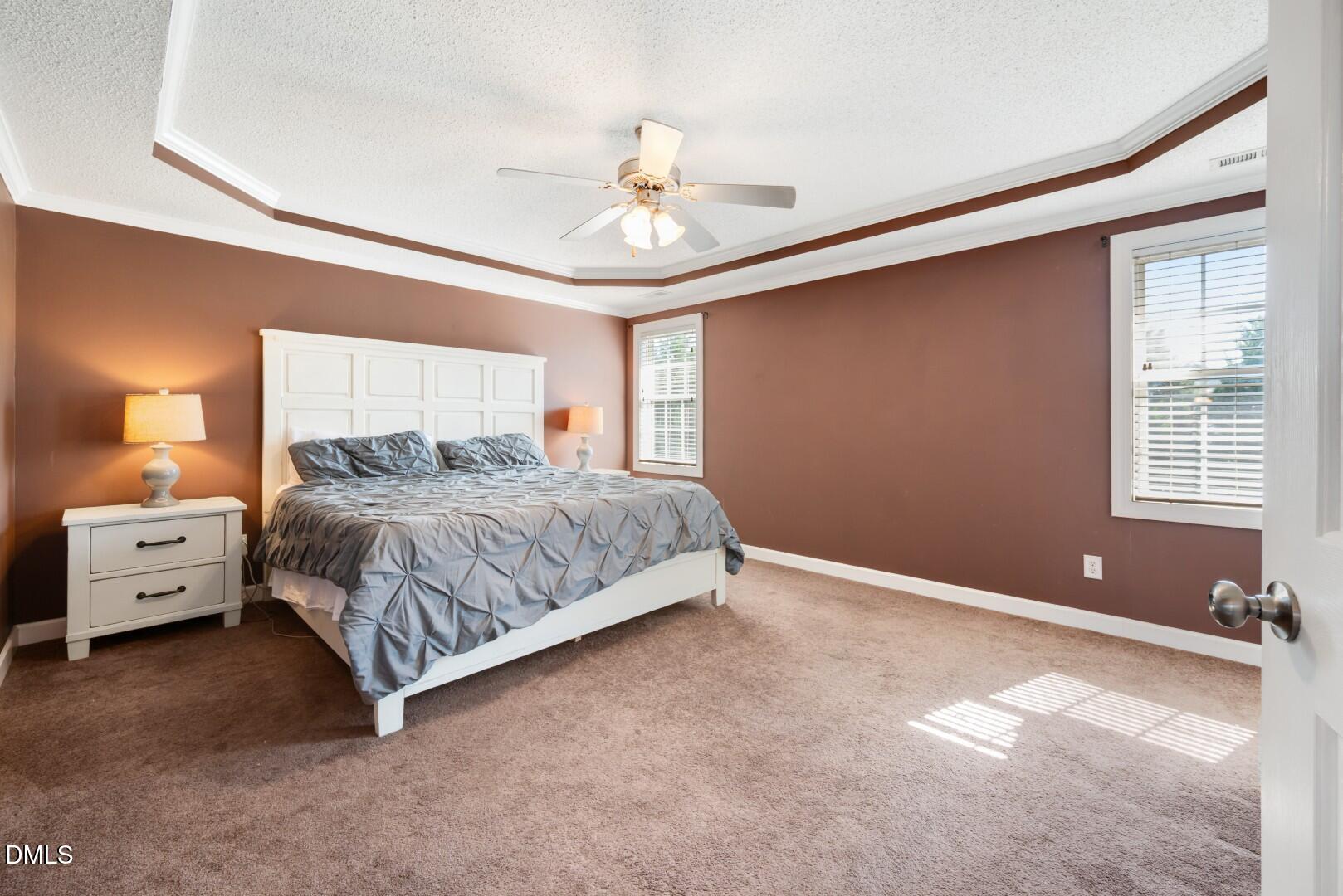 66 Snowden Lane Cameron, NC 28326 - Photo 27 of 55 a spacious bedroom with a bed and a chandelier