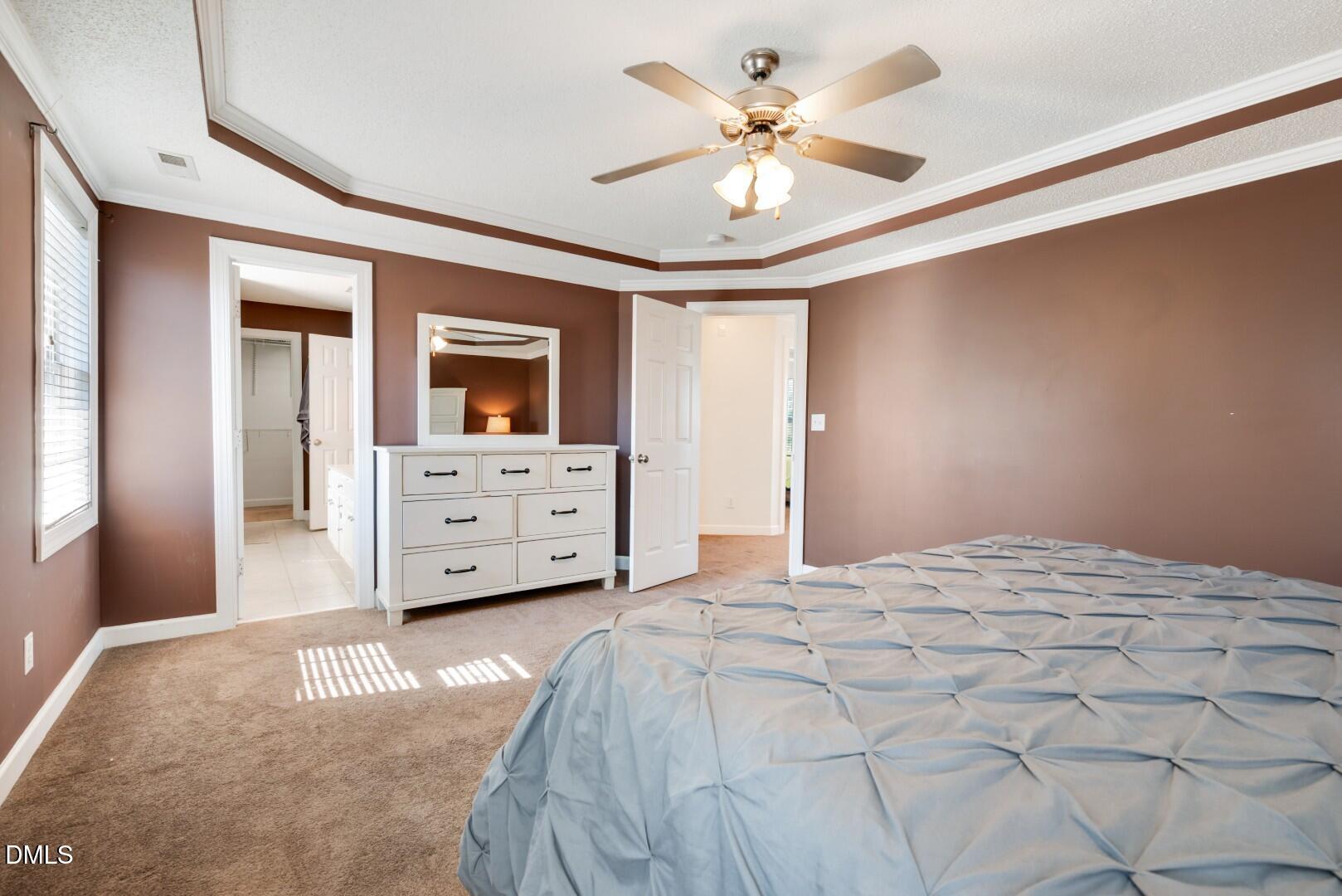 66 Snowden Lane Cameron, NC 28326 - Photo 28 of 55 a spacious bedroom with a bed and a chandelier