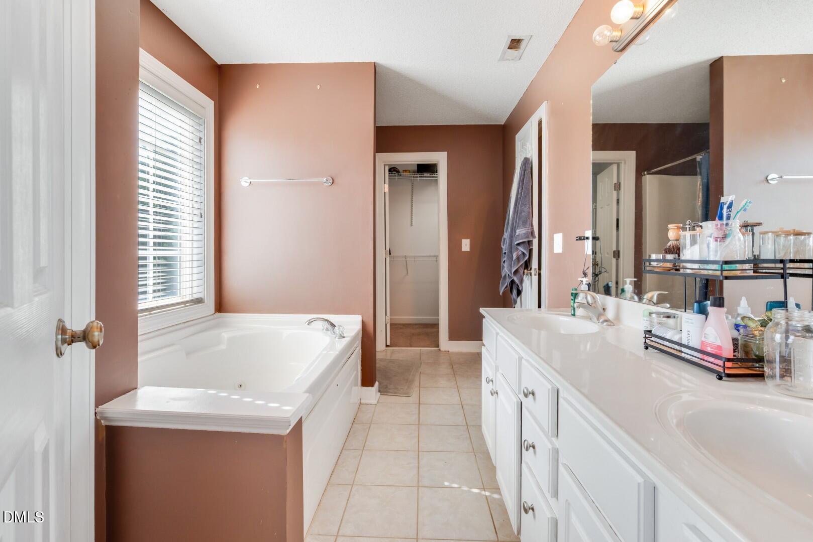 66 Snowden Lane Cameron, NC 28326 - Photo 29 of 55 a spacious bathroom with a tub sink and mirror