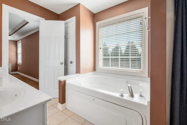 a en suite bathroom with a granite countertop tub and a sink
