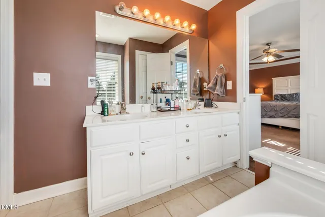 a bathroom with a double vanity sink and a mirror