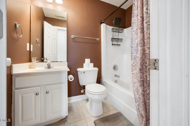 a bathroom with a sink toilet vanity and shower