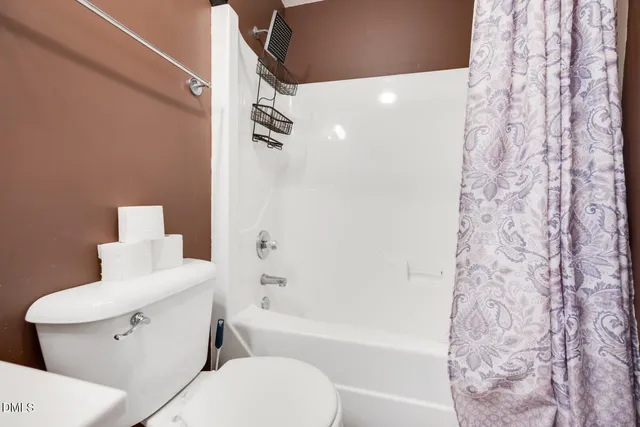 a bathroom with a toilet and a bathtub