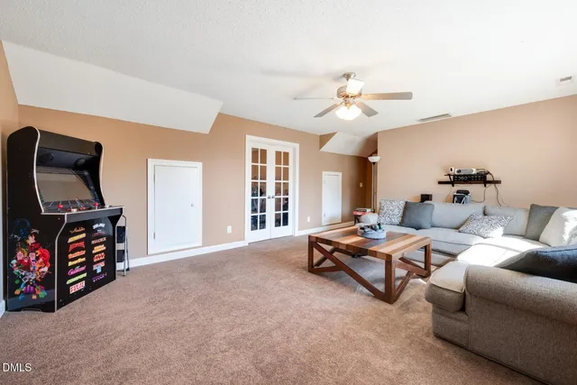 a living room with furniture gym equipment and a flat screen tv