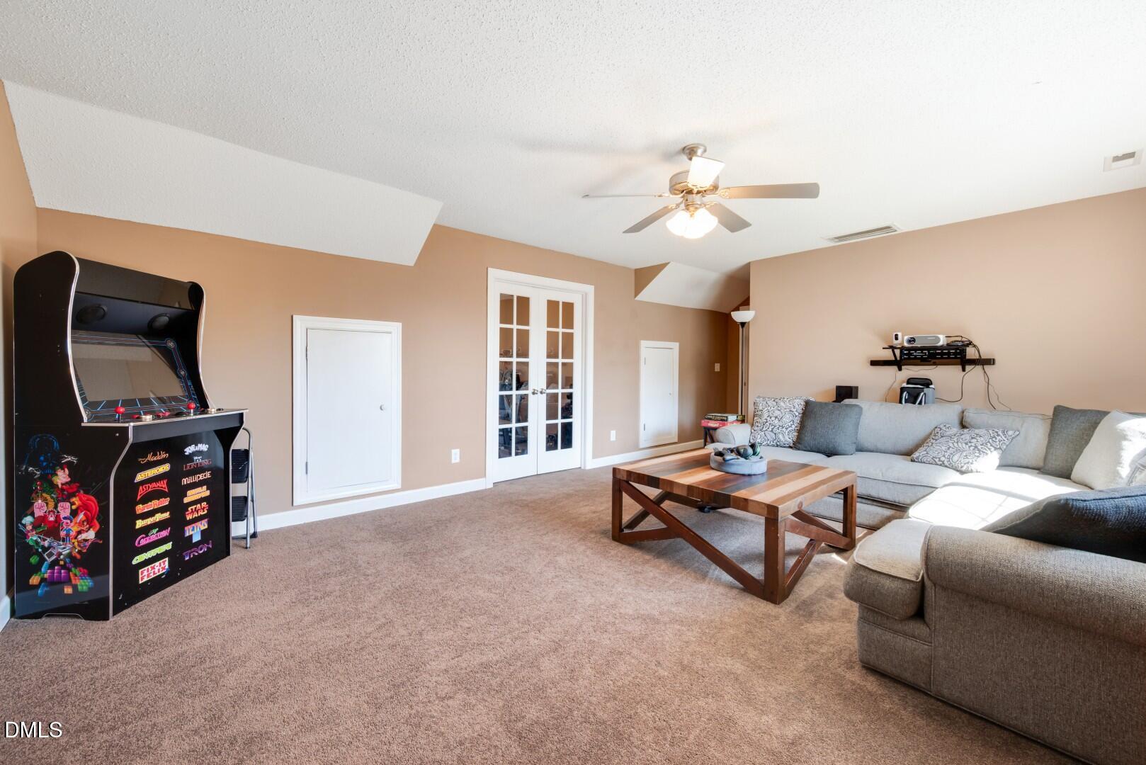 66 Snowden Lane Cameron, NC 28326 - Photo 41 of 55 a living room with furniture gym equipment and a flat screen tv