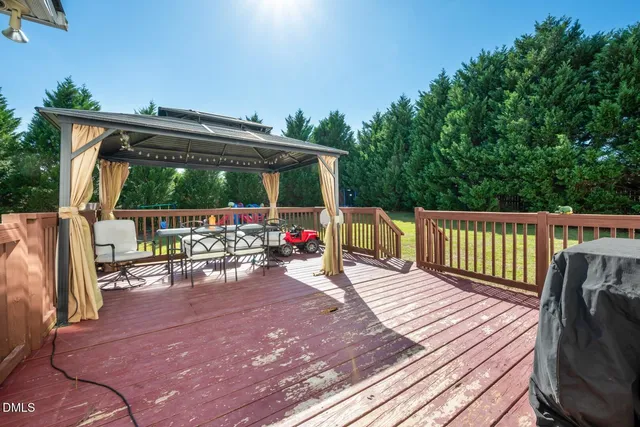 a view of a deck with wooden floor and outdoor seating