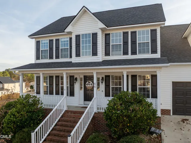 front view of a brick house with large windows