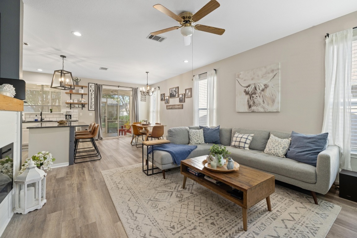 a living room with furniture and wooden floor