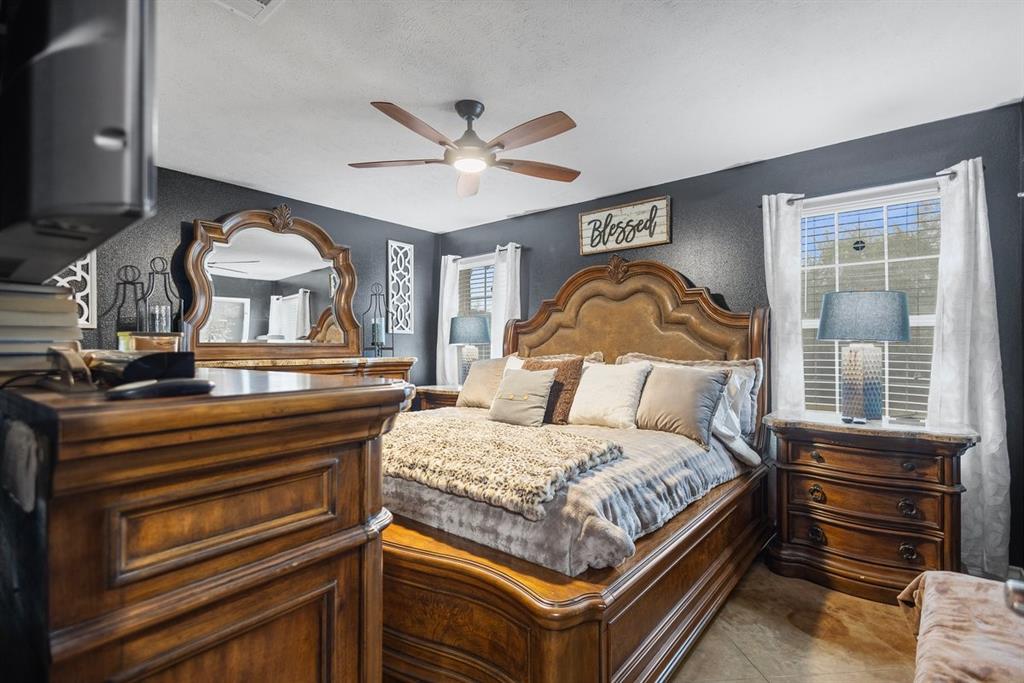 202 Spring Valley Queen City, TX 75572 - Photo 12 of 35 Bedroom with ceiling fan and a textured wall