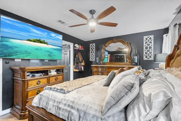 a bedroom with a bed and a chandelier