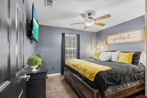 a bedroom with a bed and a chandelier