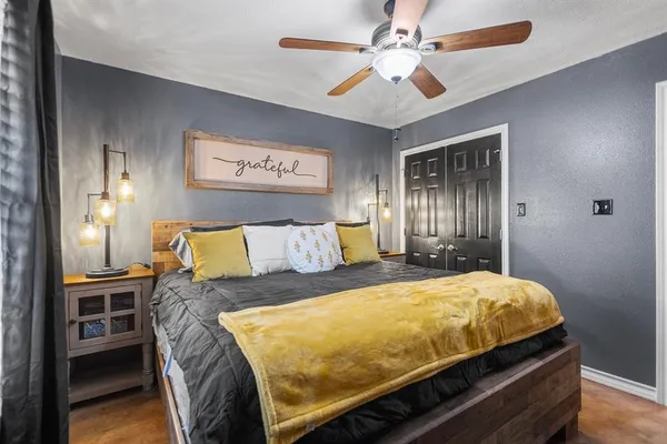 a bed sitting in a bedroom and table