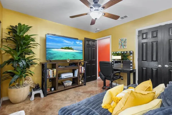 a living room with furniture and a flat screen tv