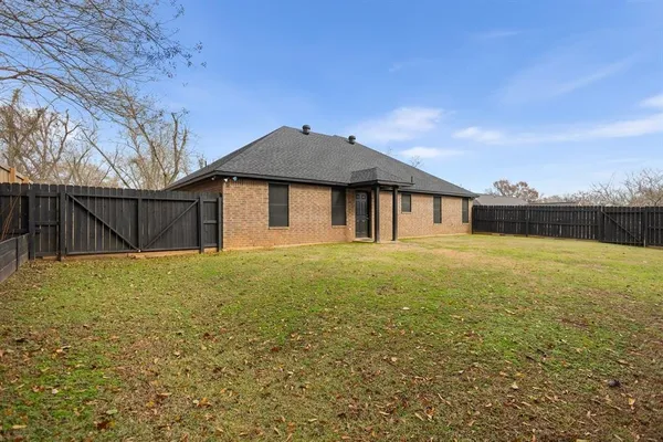 a front view of a house with yard and tree