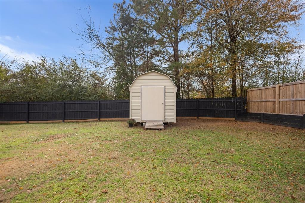 202 Spring Valley Queen City, TX 75572 - Photo 27 of 35 Fenced backyard featuring a shed
