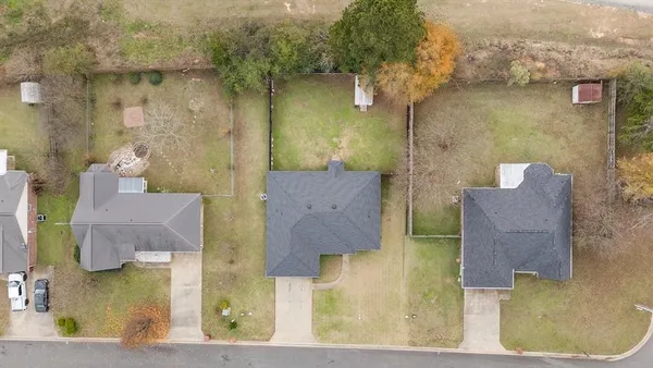 an aerial view of residential houses with outdoor space