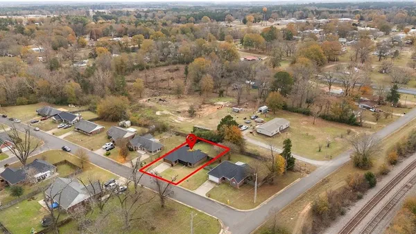an aerial view of a house with a yard