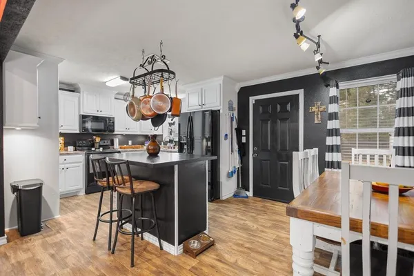 a kitchen view with stainless steel appliances granite countertop a stove and a refrigerator