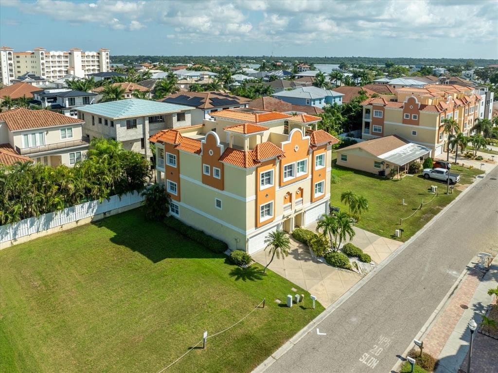an aerial view of residential houses with outdoor space and swimming pool