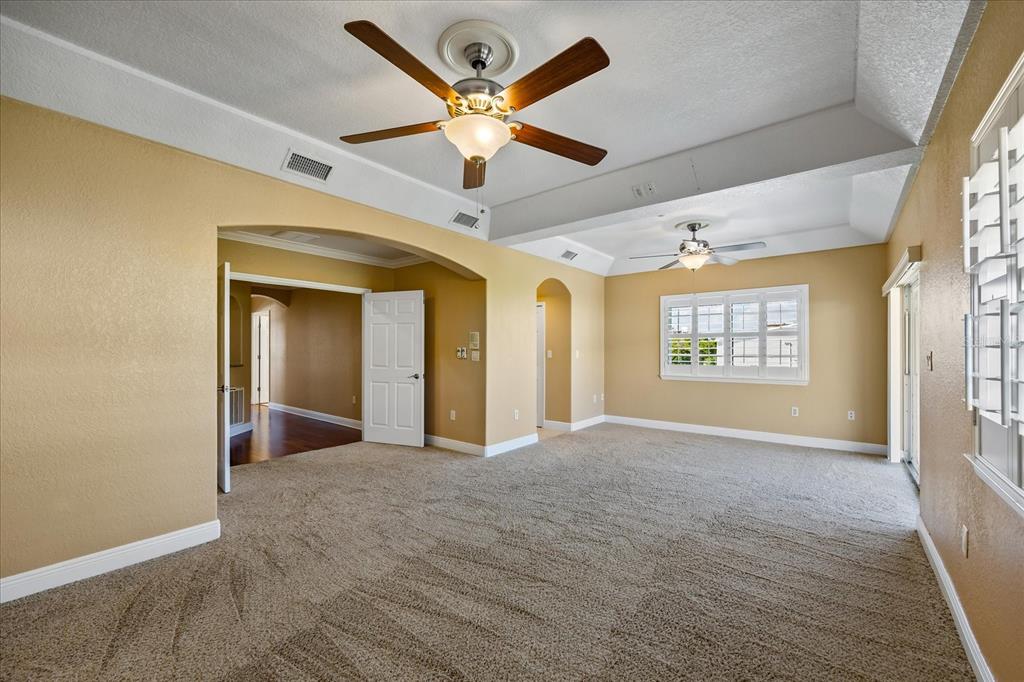 136 175th Avenue East Redington Shores, FL 33708 - Photo 14 of 40 a view of a hallway with a window and a ceiling fan