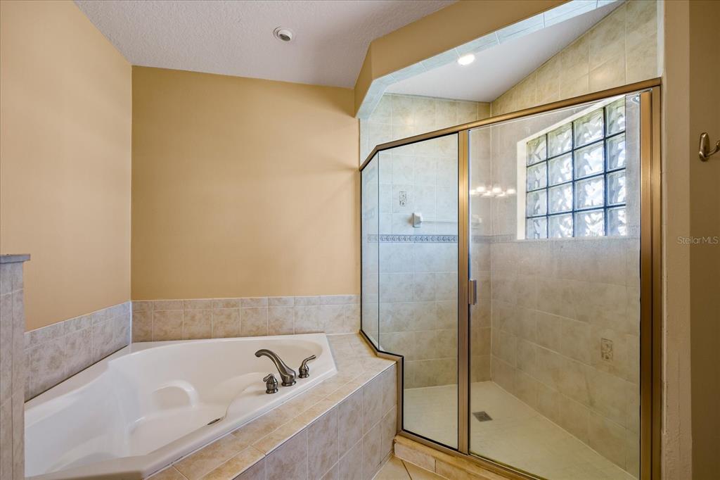 136 175th Avenue East Redington Shores, FL 33708 - Photo 16 of 40 a bathroom with a tub and shower