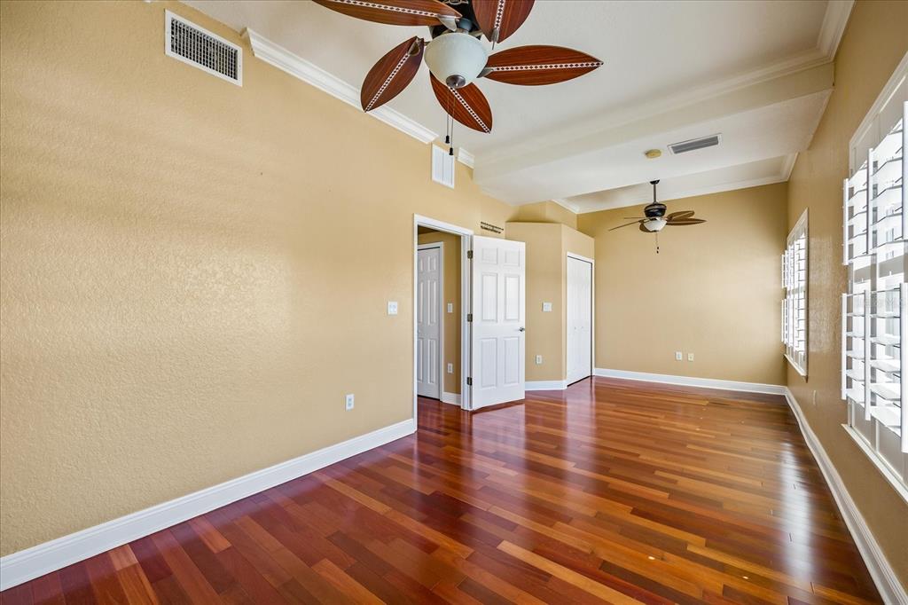 136 175th Avenue East Redington Shores, FL 33708 - Photo 19 of 40 a view of an empty room with wooden floor