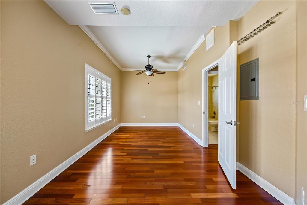 136 175th Avenue East Redington Shores, FL 33708 - Photo 20 of 40 a view of an empty room with wooden floor and a window