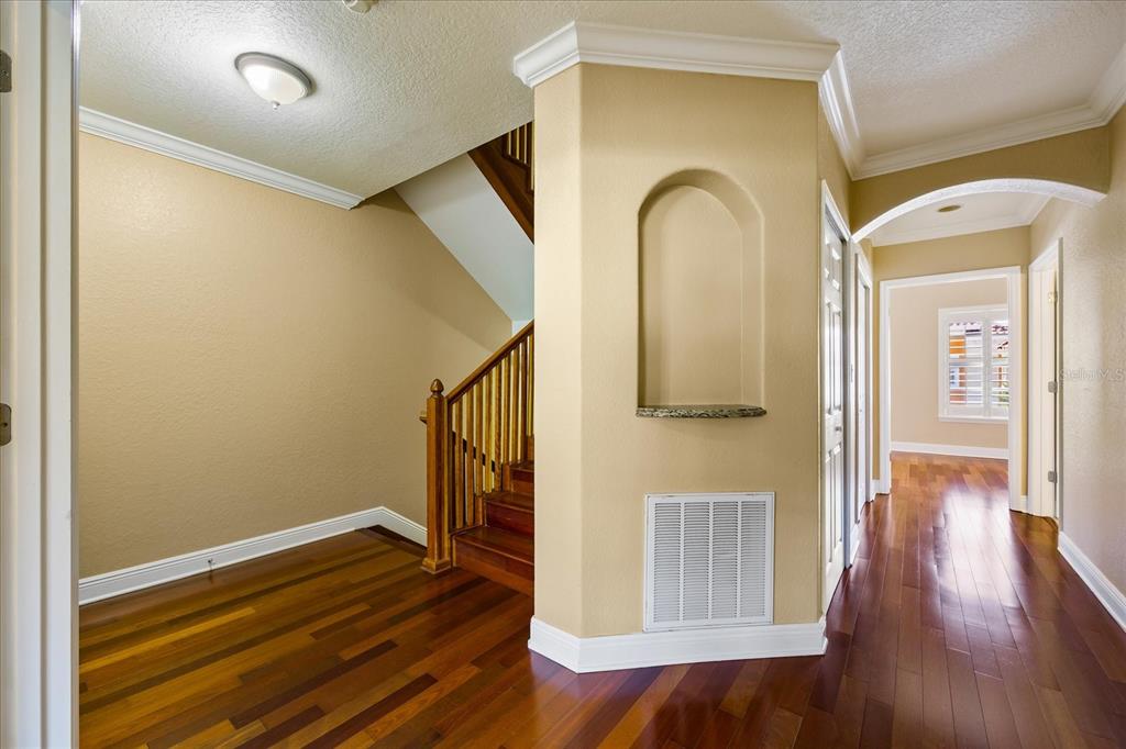 136 175th Avenue East Redington Shores, FL 33708 - Photo 25 of 40 a view of a hallway with wooden floor and staircase