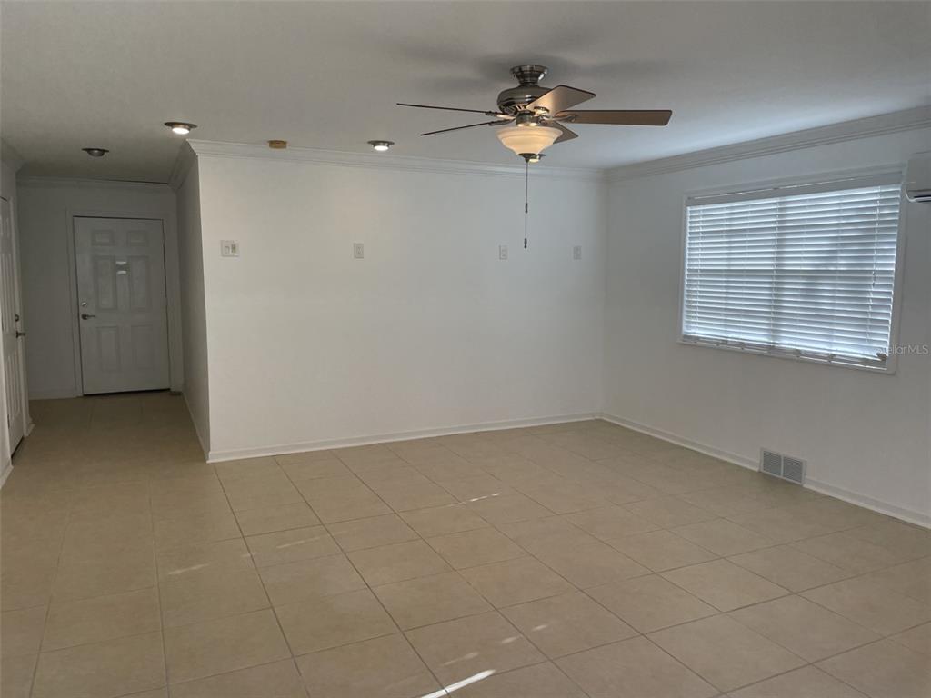 136 175th Avenue East Redington Shores, FL 33708 - Photo 30 of 40 wooden floor in an empty room with a window