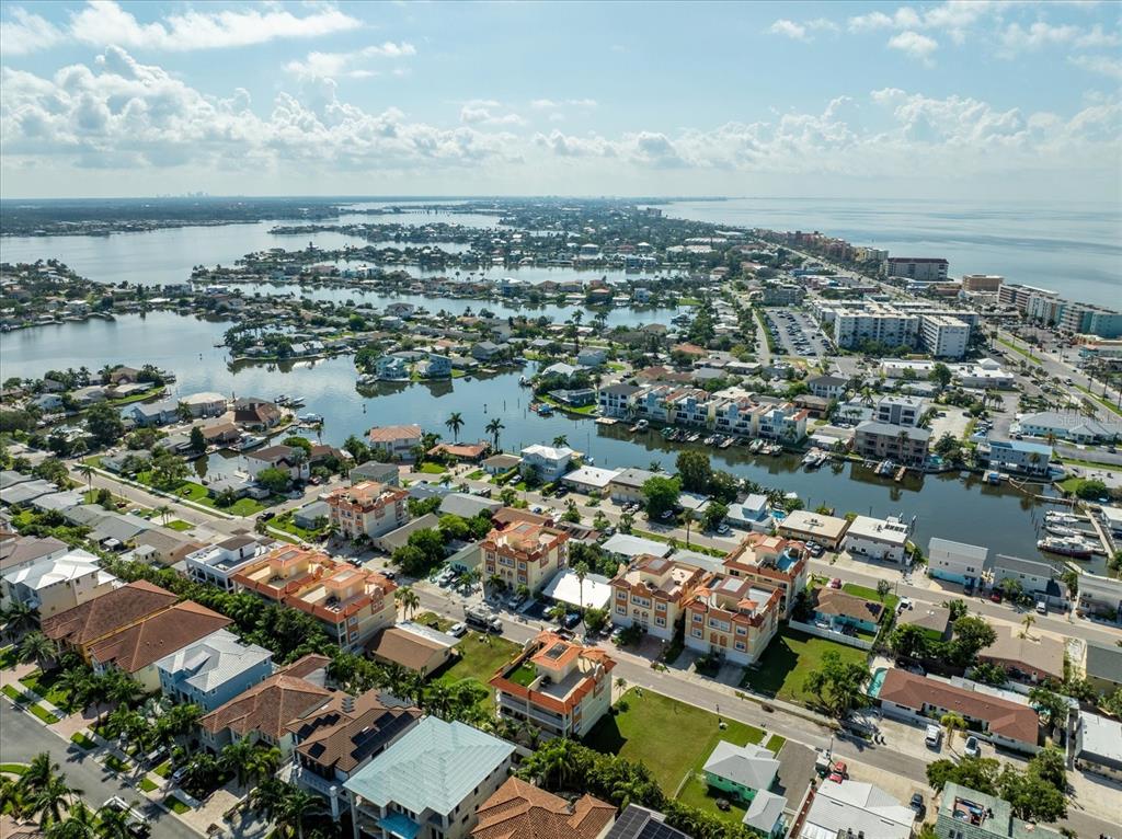 136 175th Avenue East Redington Shores, FL 33708 - Photo 37 of 40 an aerial view of a city with lots of residential buildings and ocean view in back