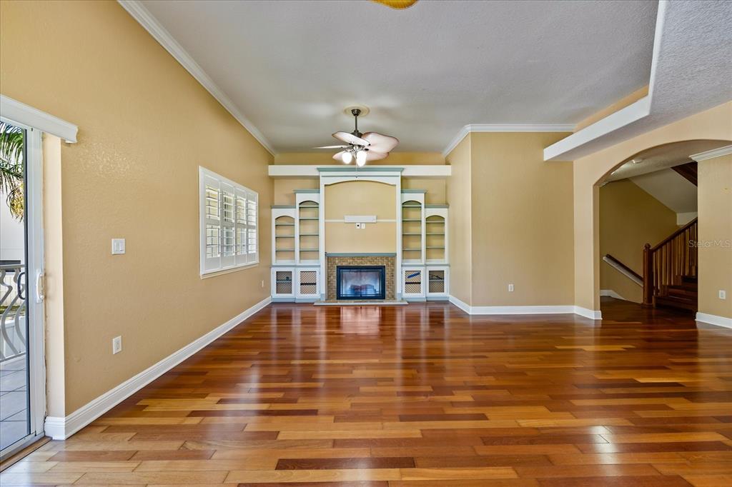 136 175th Avenue East Redington Shores, FL 33708 - Photo 10 of 40 a view of a livingroom with wooden floor and a ceiling fan
