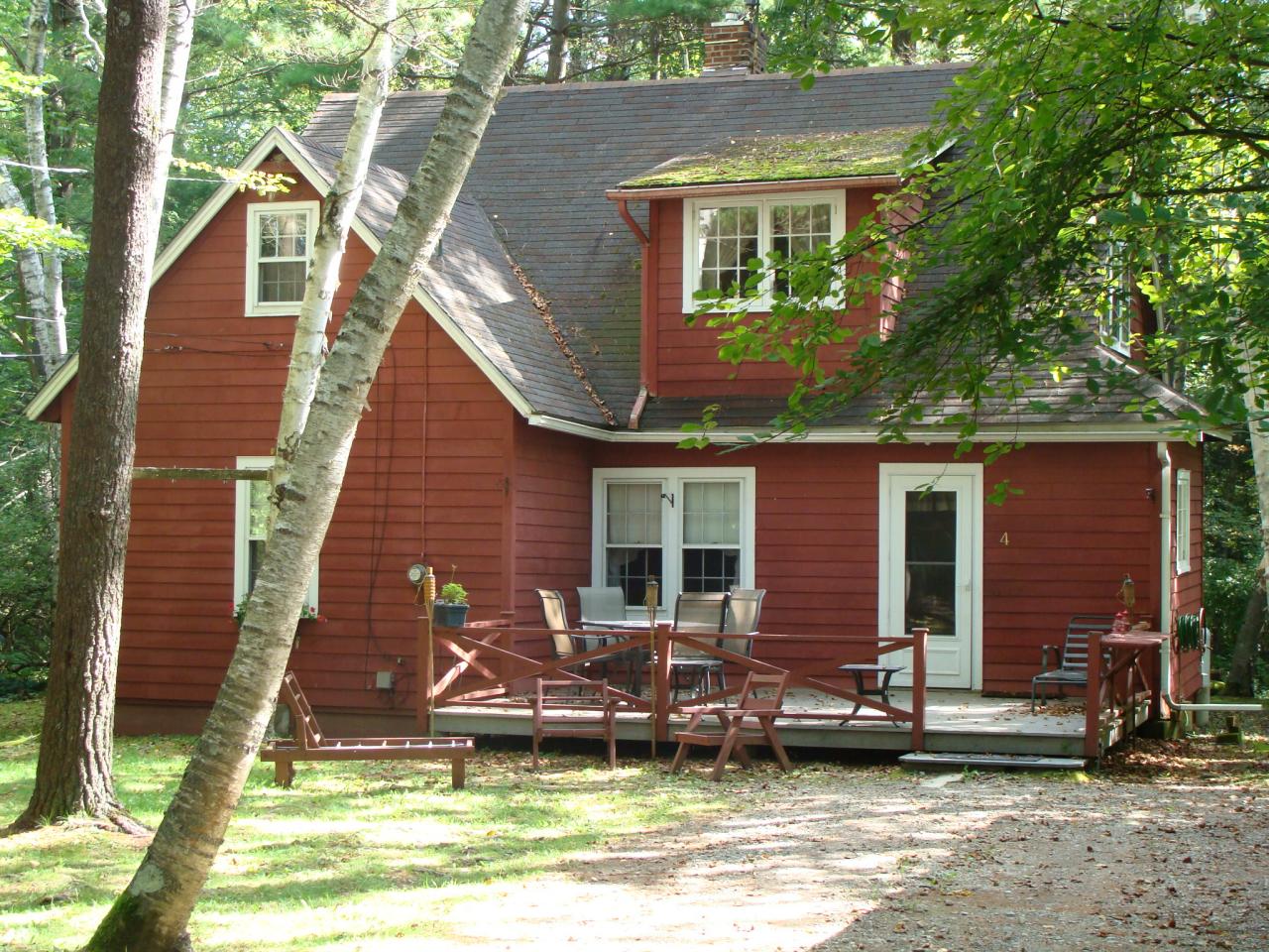 a view of a house with backyard porch and sitting area