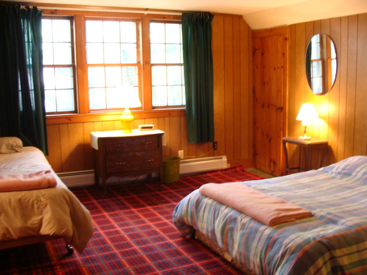 4 Grove Road Stockbridge, MA 01262 - Photo 14 of 16 a bedroom with a bed and wooden floor