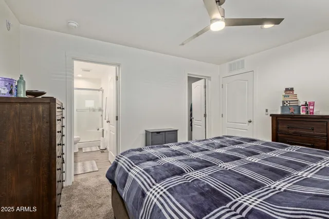 a bed sitting in a bedroom next to a window